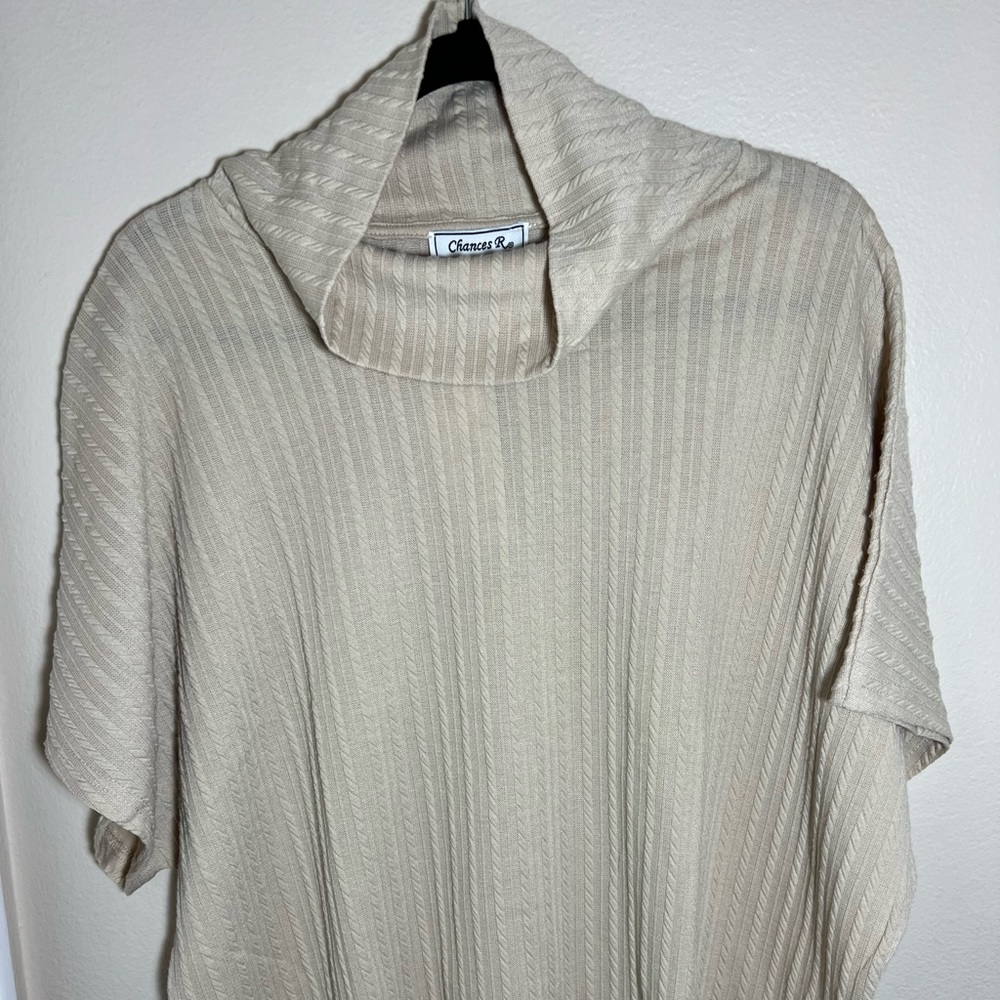 Cream colored woman’s top, brand new with tags.